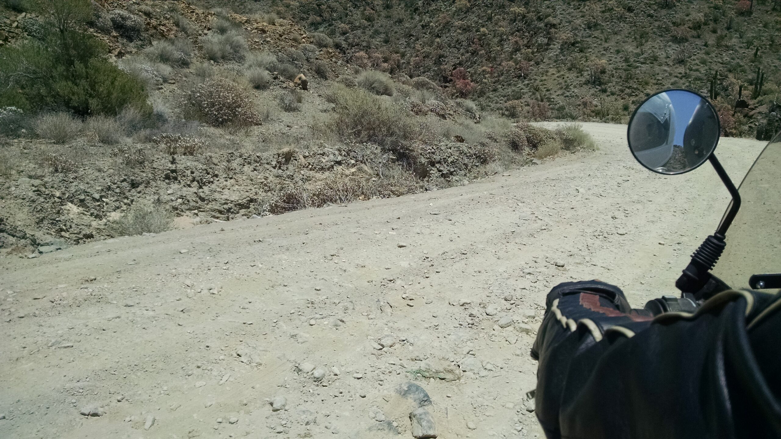 A view of a rocky road from the pillion seat of Skyler's motorcycle
